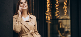 woman standing by cafe using phone