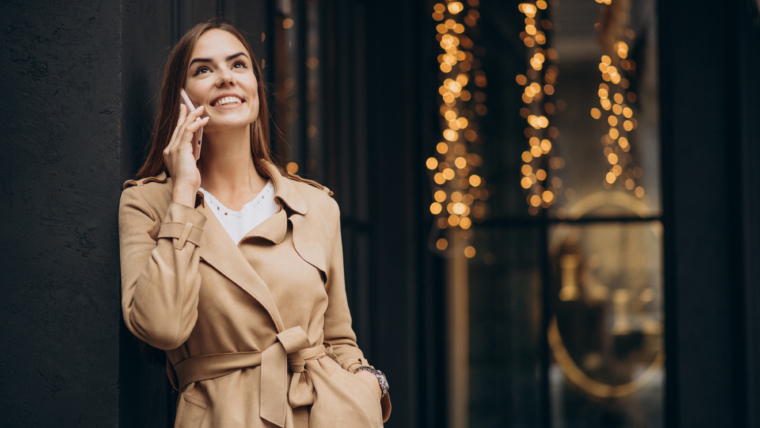 What Makes a Voice Feminine? 1 woman standing by cafe using phone