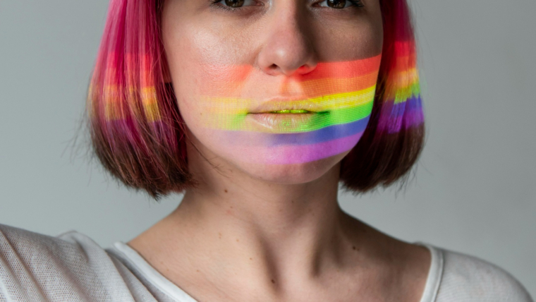 Transcending Gender Norms: A Guide for Transgender Women on Embracing Femininity 1 portrait woman with lgbt symbol