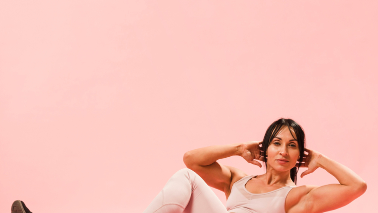Feminine Fitness: Workouts That Empower and Energize 1 side view athletic woman gym outfit doing crunches