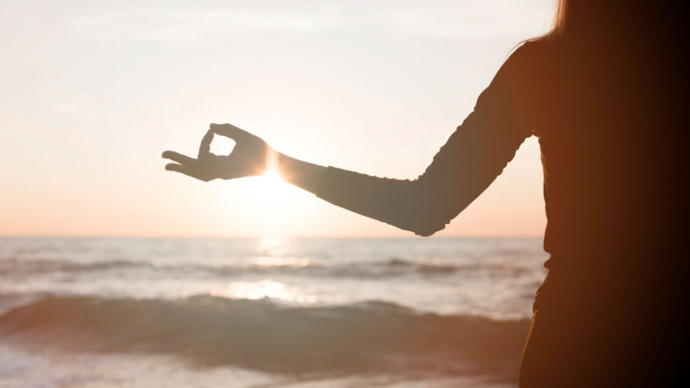 Feminine Health and Wellness 1 woman meditating sunset beach
