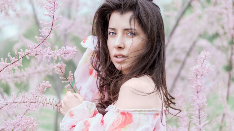 How to Look More Feminine: 8 Secret Tips to Unleash Your Inner Goddess 1 woman standing near pink leafed plant